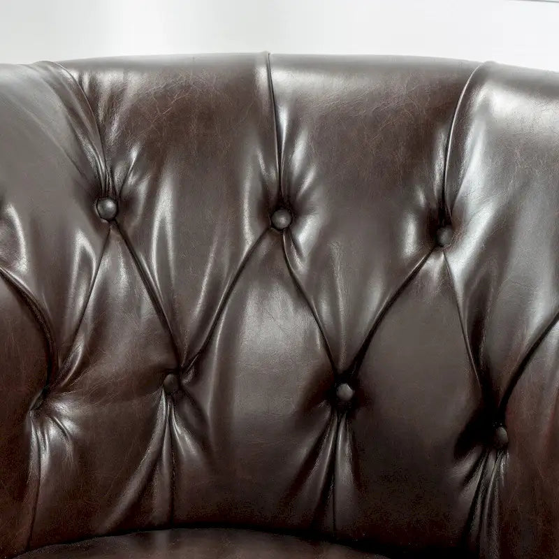 Fauteuil club en similicuir capitonné de
